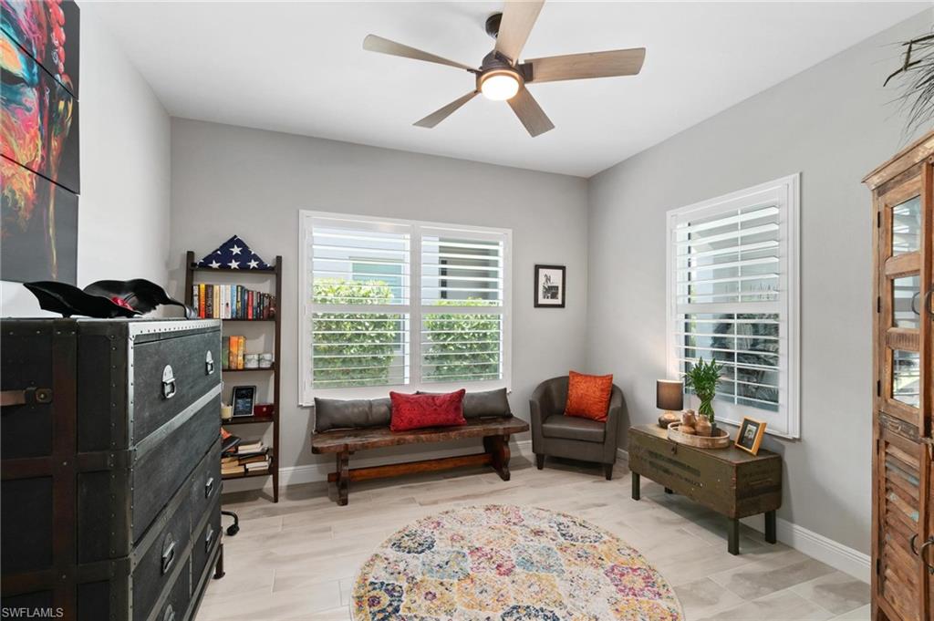 2298 Marquesa Circle Naples, FL 34112 - Photo 20 of 50 a living room with furniture toys and a window