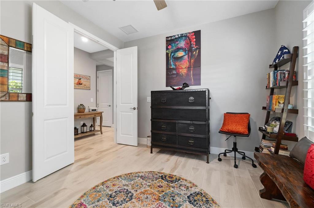 2298 Marquesa Circle Naples, FL 34112 - Photo 21 of 50 a bedroom with furniture and wooden floor