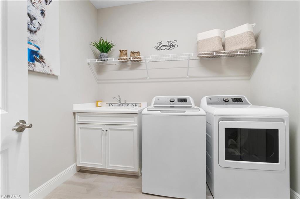 2298 Marquesa Circle Naples, FL 34112 - Photo 23 of 50 a utility room with sink dryer and washer