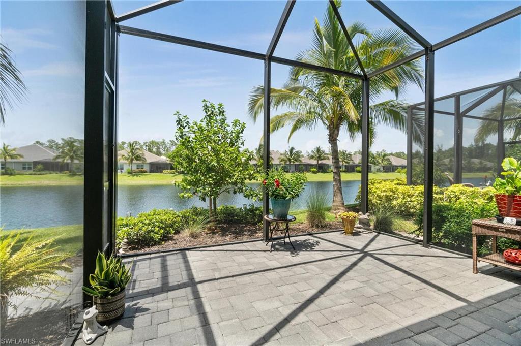 2298 Marquesa Circle Naples, FL 34112 - Photo 26 of 50 a view of swimming pool with a patio and a garden