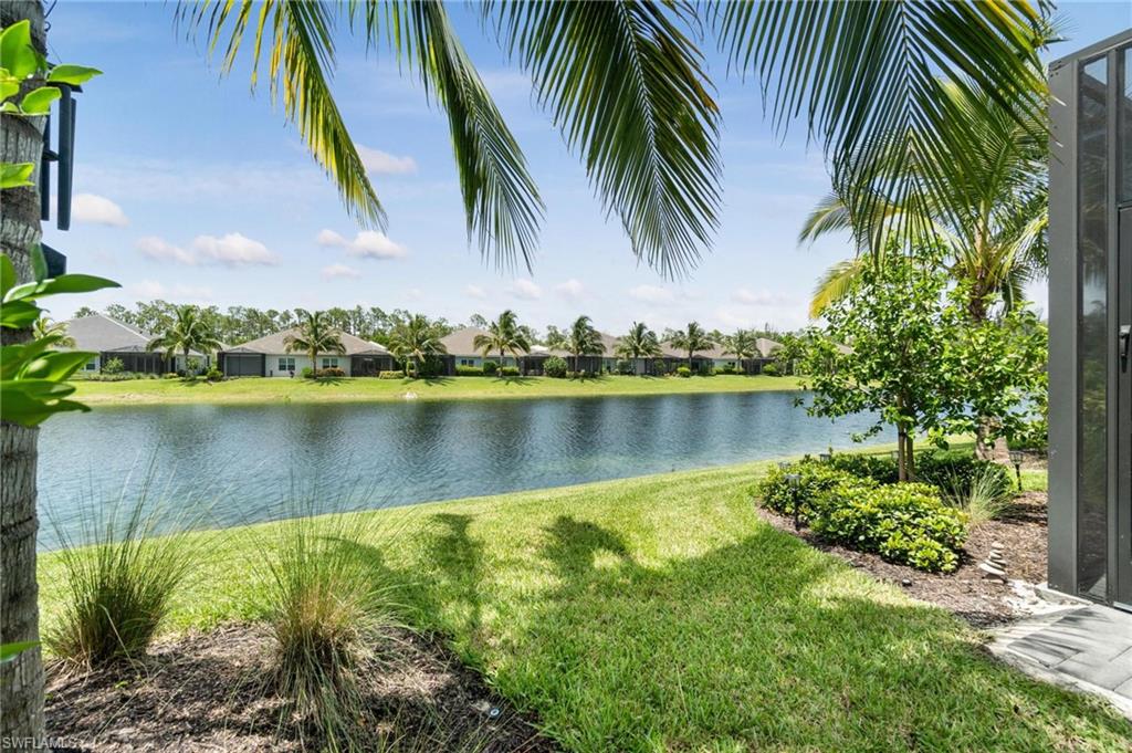 2298 Marquesa Circle Naples, FL 34112 - Photo 29 of 50 a view of a lake with a palm trees