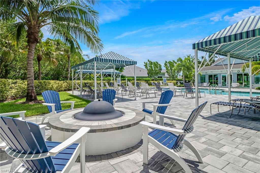 2298 Marquesa Circle Naples, FL 34112 - Photo 48 of 50 a view of a patio with a table chairs and a backyard