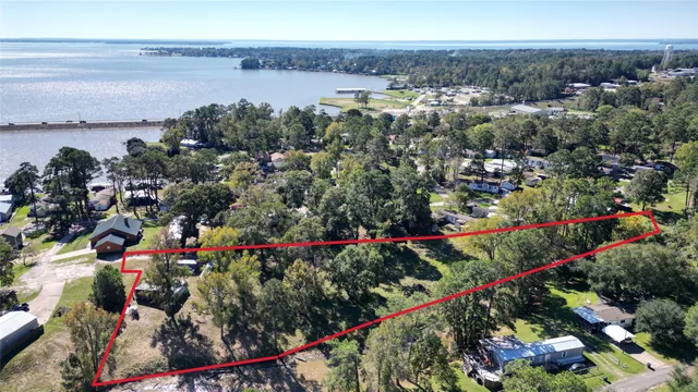 a view of a lake with a flower garden and wooden floor