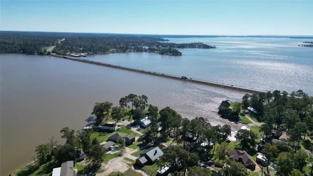 a view of a lake with a mountain and a floor to ceiling window