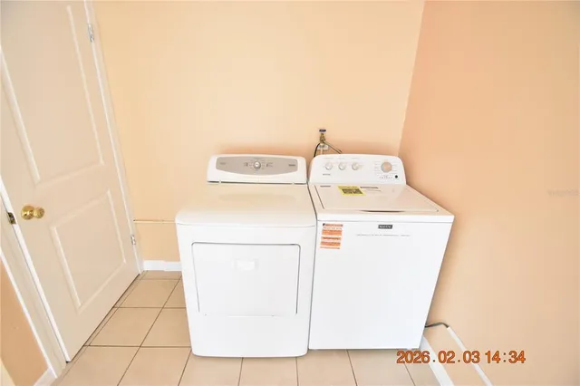 a white toilet sitting next to a bathroom sink and vanity