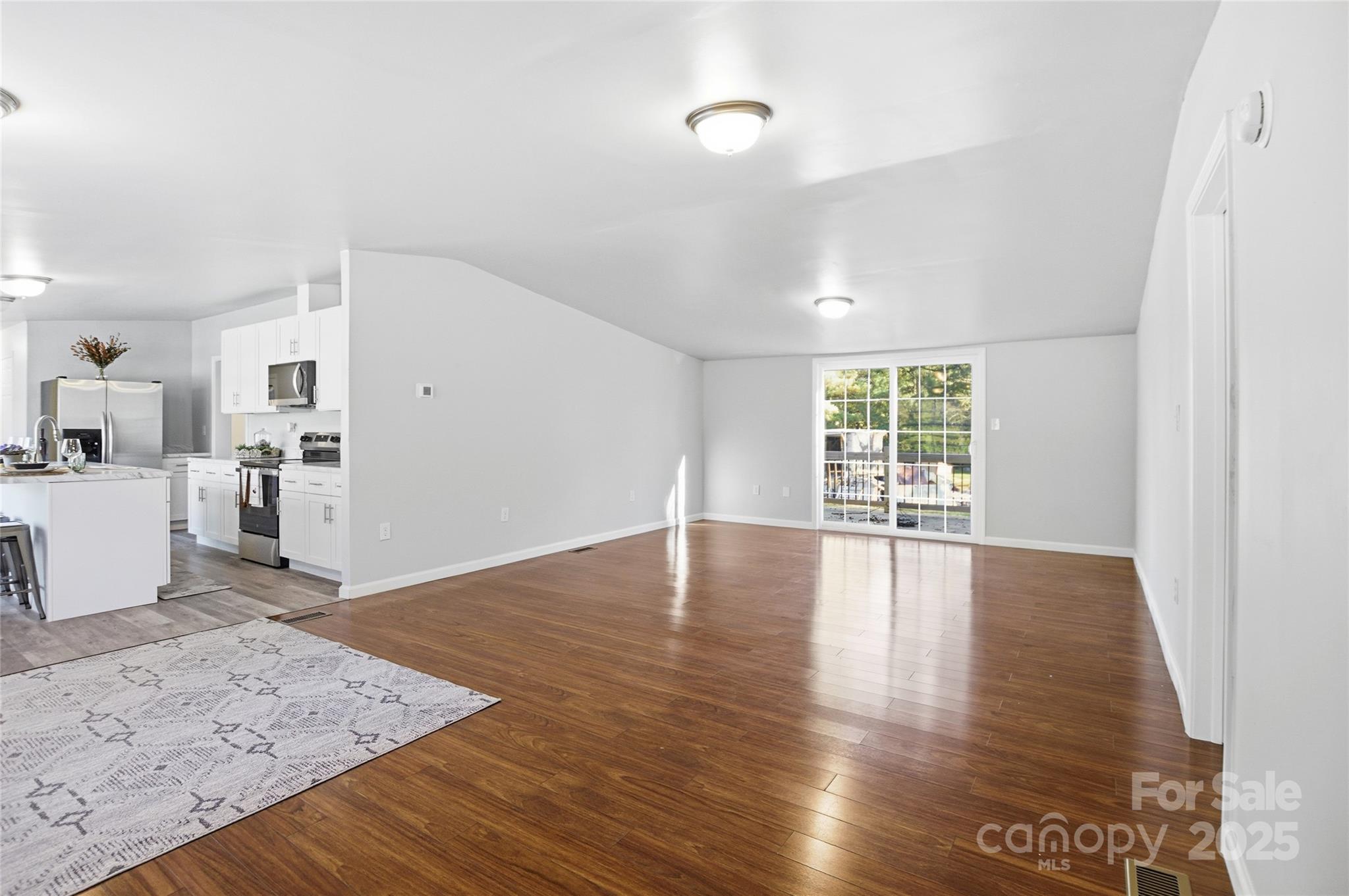 2425 Shoal Creek Church Road Shelby, NC 28152 - Photo 13 of 33 a view of a kitchen with wooden floor and a window