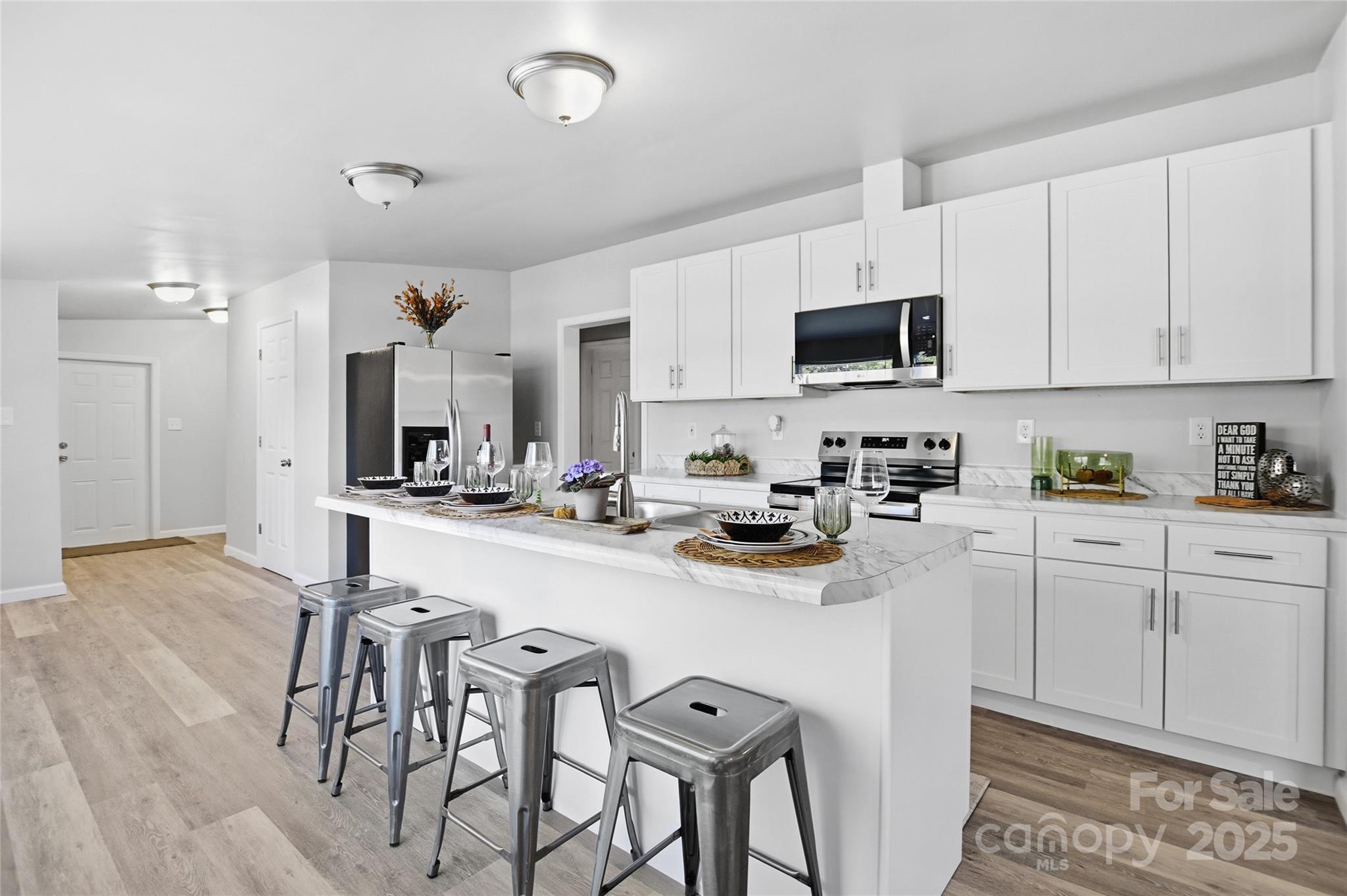 2425 Shoal Creek Church Road Shelby, NC 28152 - Photo 20 of 33 a kitchen with stainless steel appliances a sink a stove a table and chairs