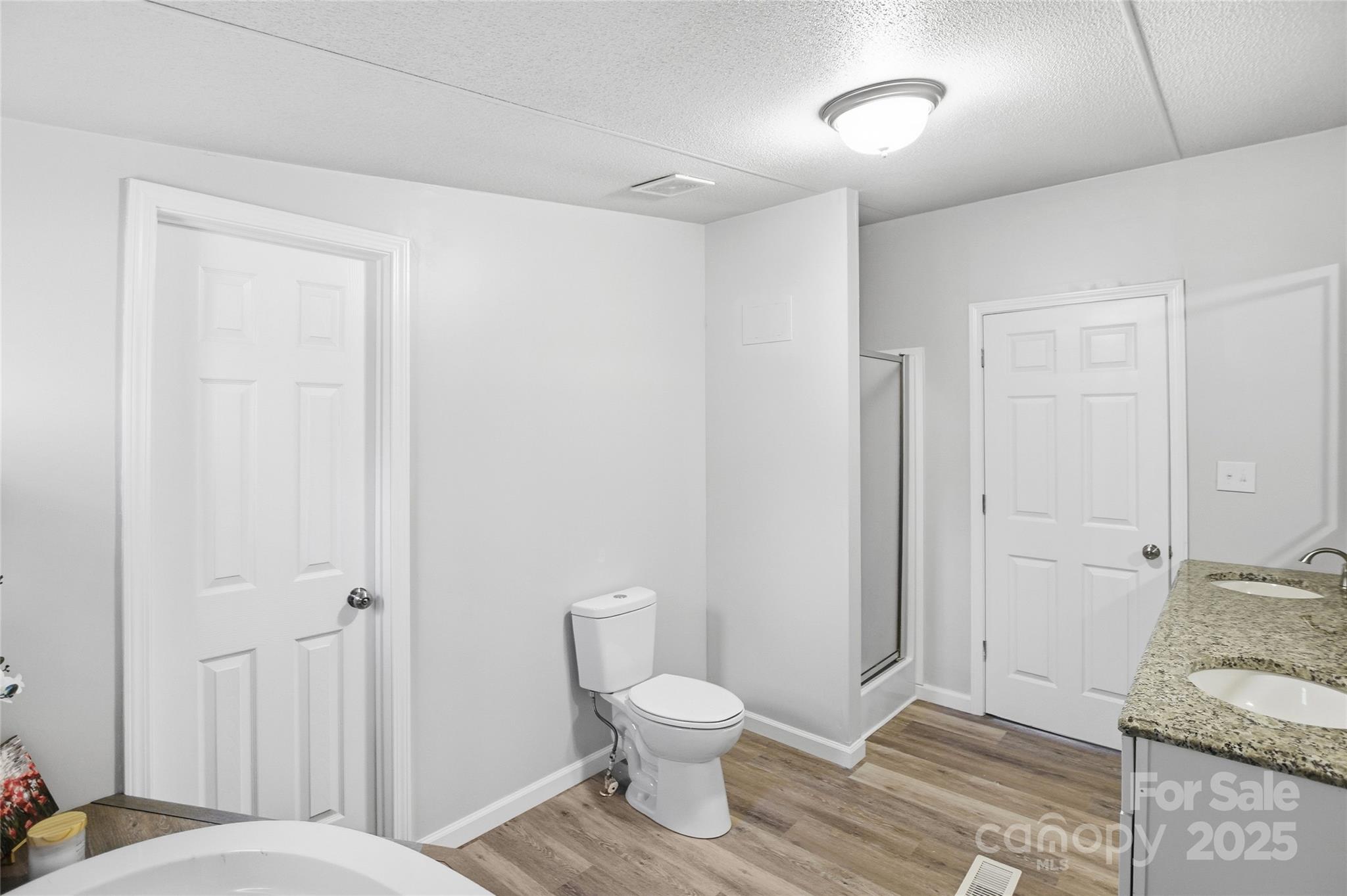 2425 Shoal Creek Church Road Shelby, NC 28152 - Photo 26 of 33 a bathroom with a granite countertop toilet and a sink