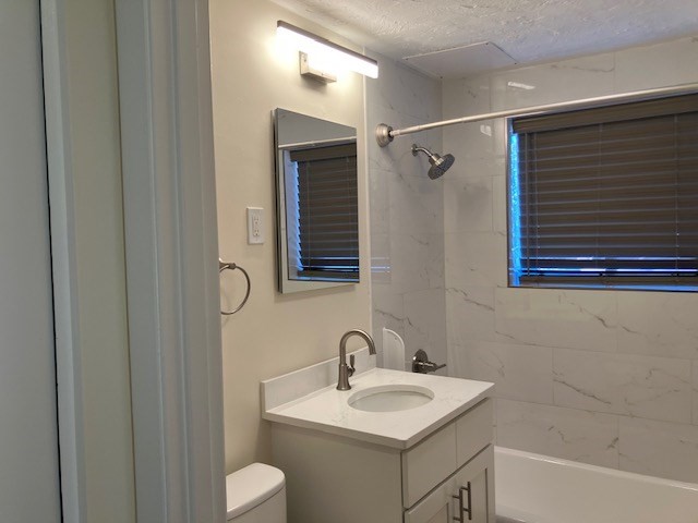 116 Trapelo Road, Unit 4 Waltham, MA 02452 - Photo 3 of 4 a bathroom with a toilet sink and mirror