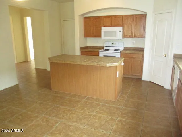 a kitchen with stainless steel appliances a stove a sink and a refrigerator