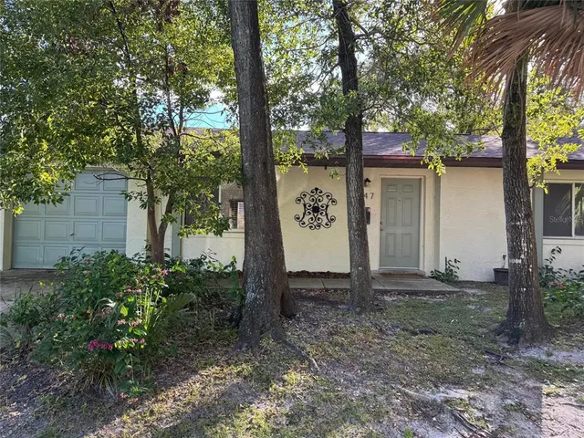 a view of a tree in front of a house