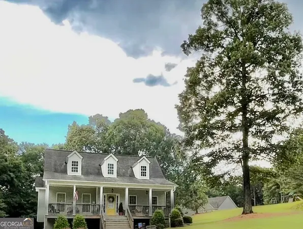 a front view of a residential apartment building with a yard