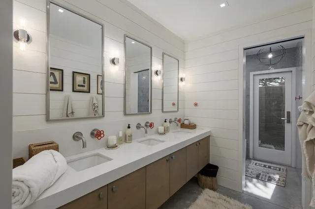 a bathroom with double vanity sinks and a mirror