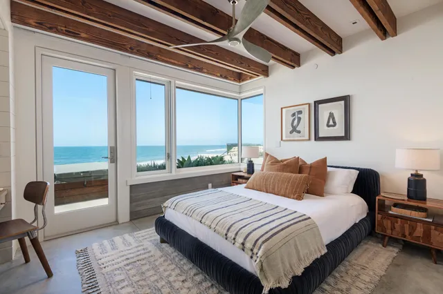 a bedroom with a large bed and a balcony view