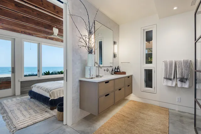 a spacious en suite bathroom with a double vanity sink and a large mirror
