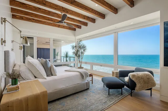 a living room with furniture and a floor to ceiling window
