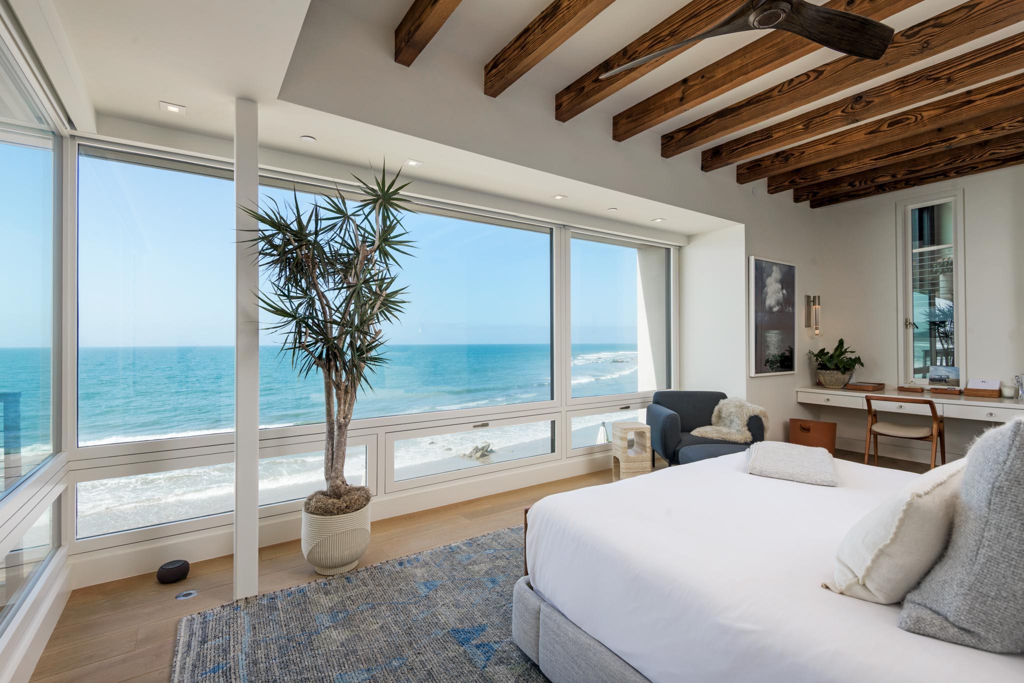 1821 Fernald Point Lane Montecito, CA 93108 - Photo 16 of 28 a spacious bedroom with a large bed and a potted plant