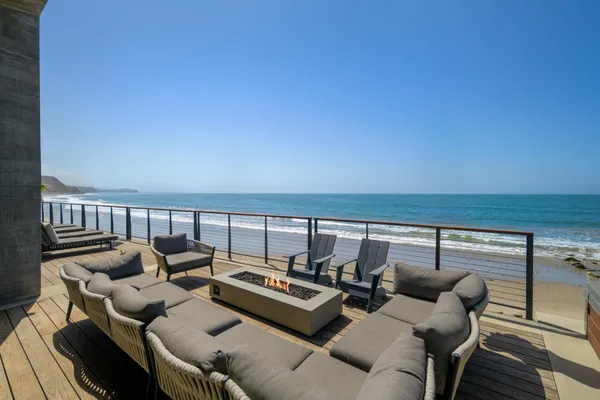 a terrace with outdoor seating and city view