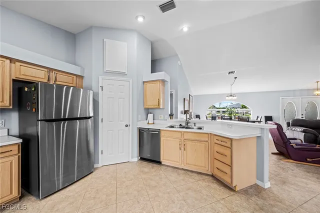 a kitchen with a refrigerator and a sink