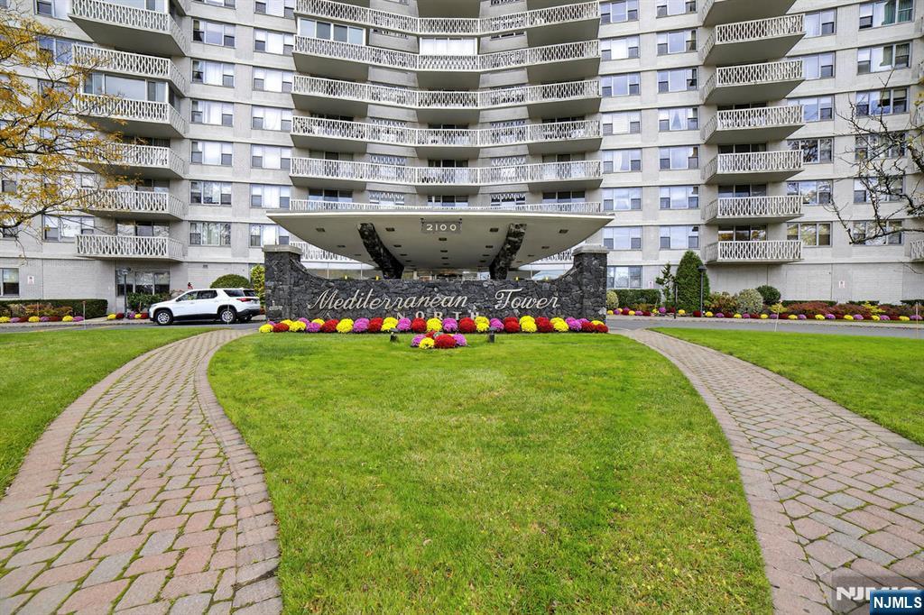 2100 Linwood Avenue, Unit 17U Fort Lee, NJ 07024 - Photo 1 of 23 a front view of building with garden