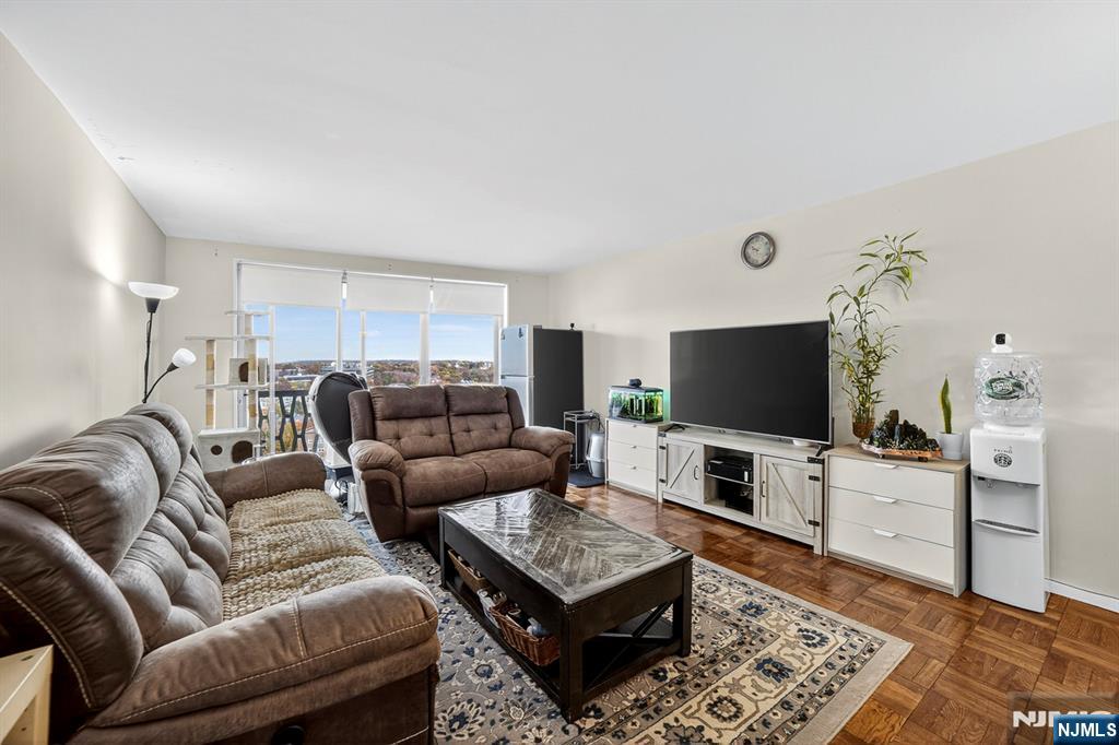 2100 Linwood Avenue, Unit 17U Fort Lee, NJ 07024 - Photo 11 of 23 a living room with furniture and a flat screen tv