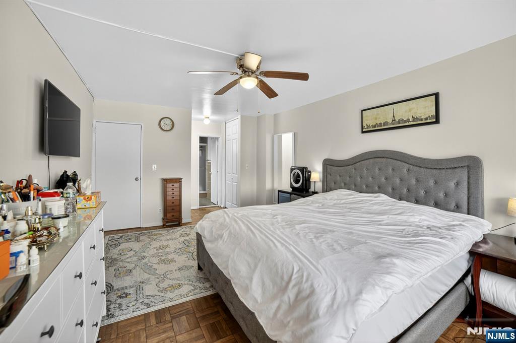 2100 Linwood Avenue, Unit 17U Fort Lee, NJ 07024 - Photo 18 of 23 a bedroom with a bed and a flat screen tv