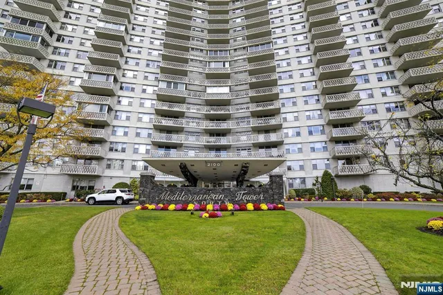 a aerial view of a building and yard with green space