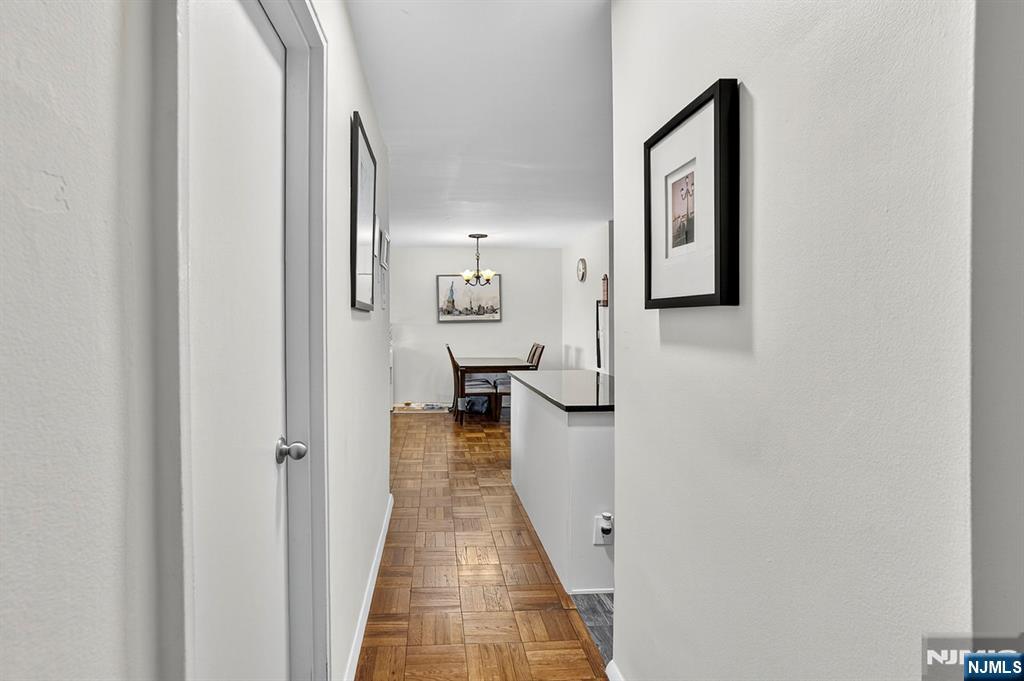 2100 Linwood Avenue, Unit 17U Fort Lee, NJ 07024 - Photo 7 of 23 a view of a hallway with wooden floor