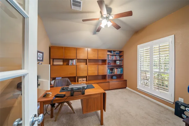 a view of a hallway with wooden floor and windows