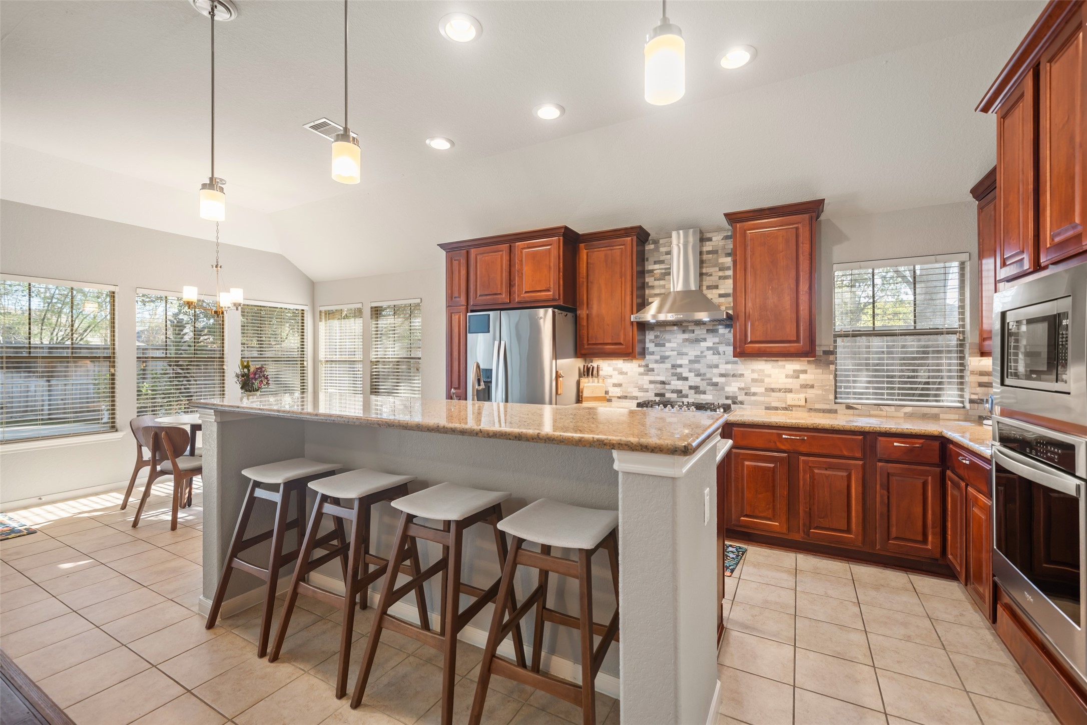 28318 Ryans Ridge Lane Spring, TX 77386 - Photo 17 of 48 a kitchen with granite countertop sink table and chairs