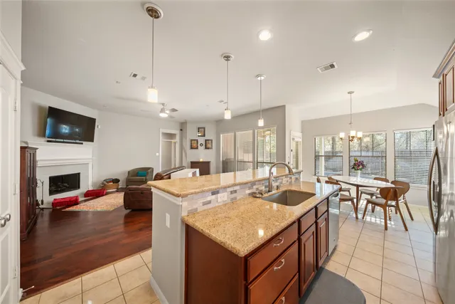 a kitchen with granite countertop sink table and chairs