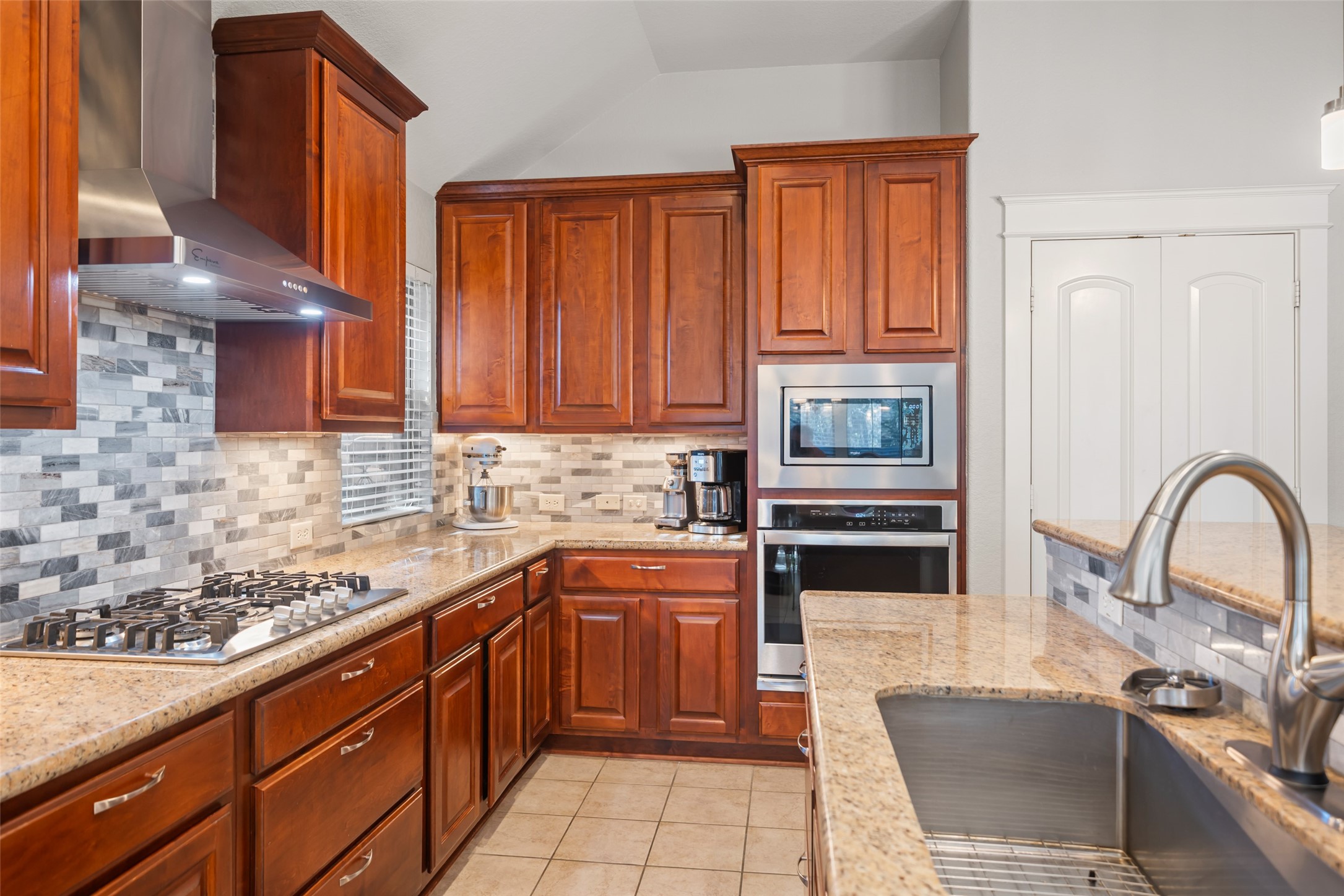 28318 Ryans Ridge Lane Spring, TX 77386 - Photo 19 of 48 a kitchen with stainless steel appliances granite countertop a stove a sink dishwasher and a microwave oven with a dining table