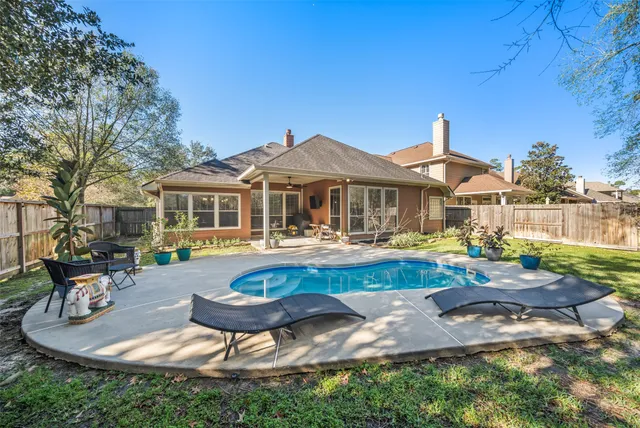 a front view of a house with swimming pool table and chairs