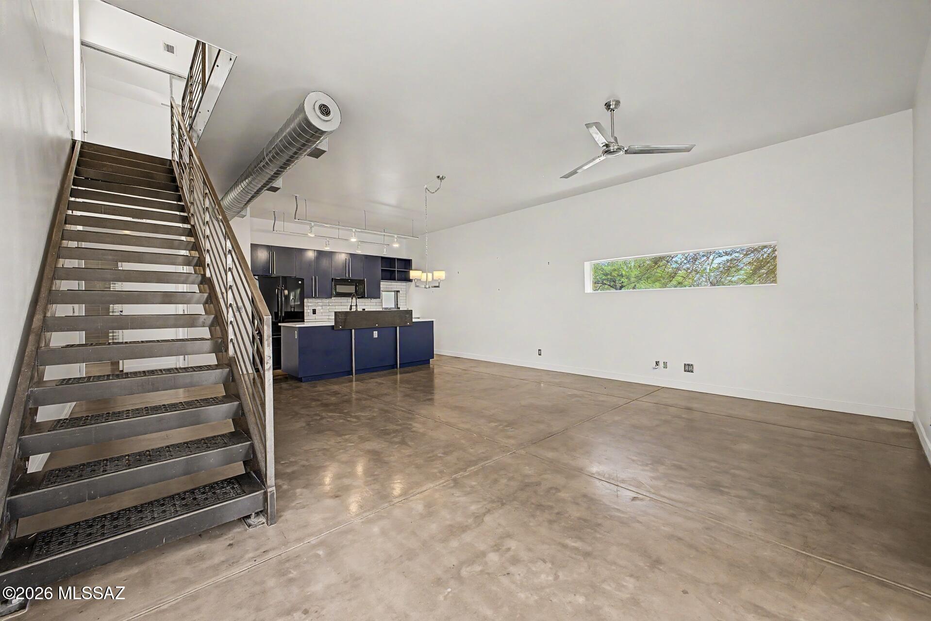 3605 East 3rd Street Tucson, AZ 85716 - Photo 12 of 39 Open concept dining/living areas with several floor to ceiling windows and access to the backyard.