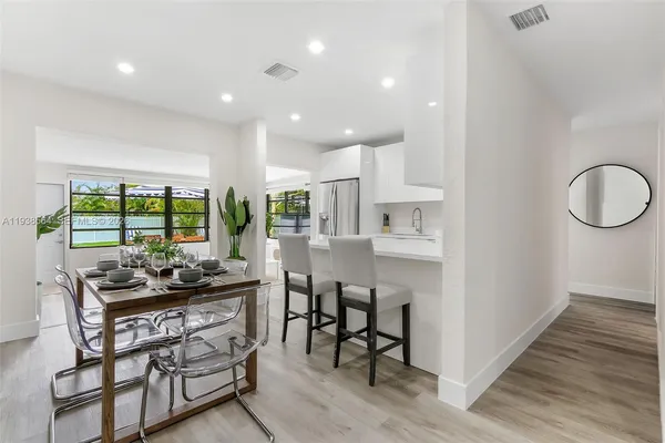 a kitchen with a table and chairs