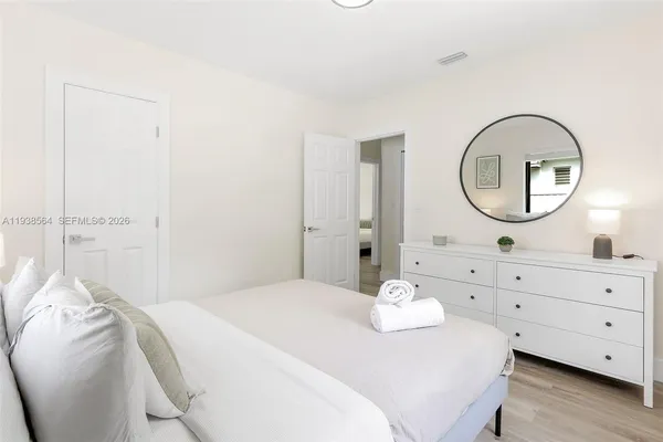 a bedroom with a bed and a dresser