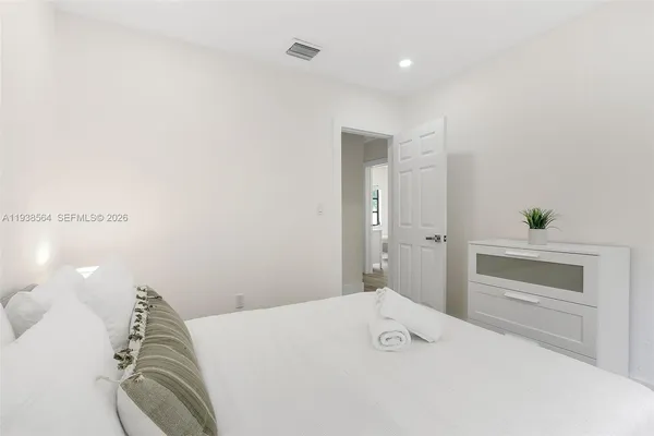 a bedroom with a bed and cabinet