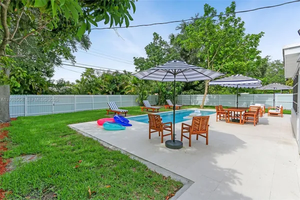 an outdoor space with patio and white umbrellas