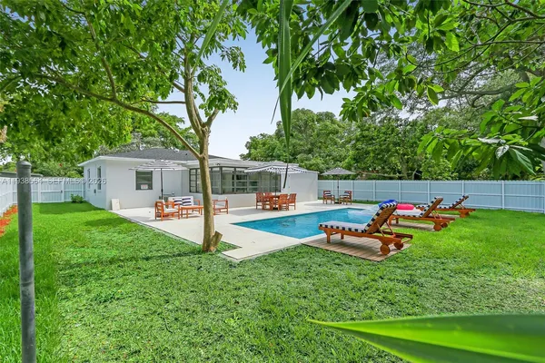 a front view of a house with swing and a garden