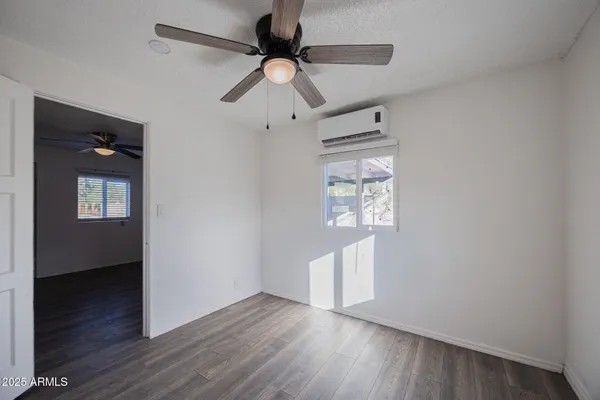 a view of an empty room and wooden floor