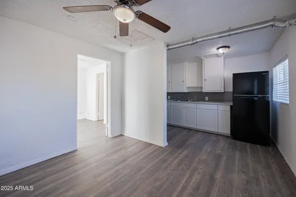 a kitchen with wooden floors and refrigerator