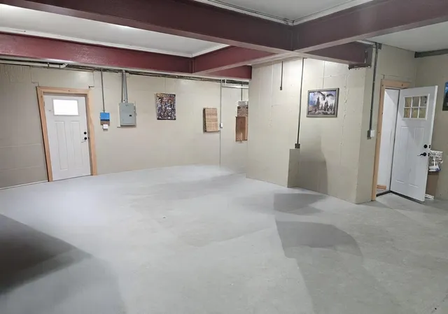 a view of a hallway with a chair and dining table view