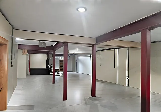 a view of a hallway with stainless steel appliances