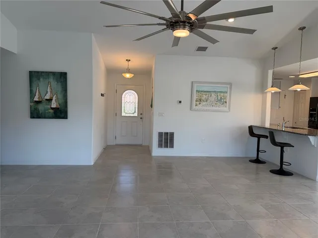 a kitchen with granite countertop a sink a stove and cabinets