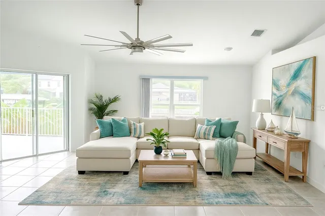 a living room with furniture and a large window