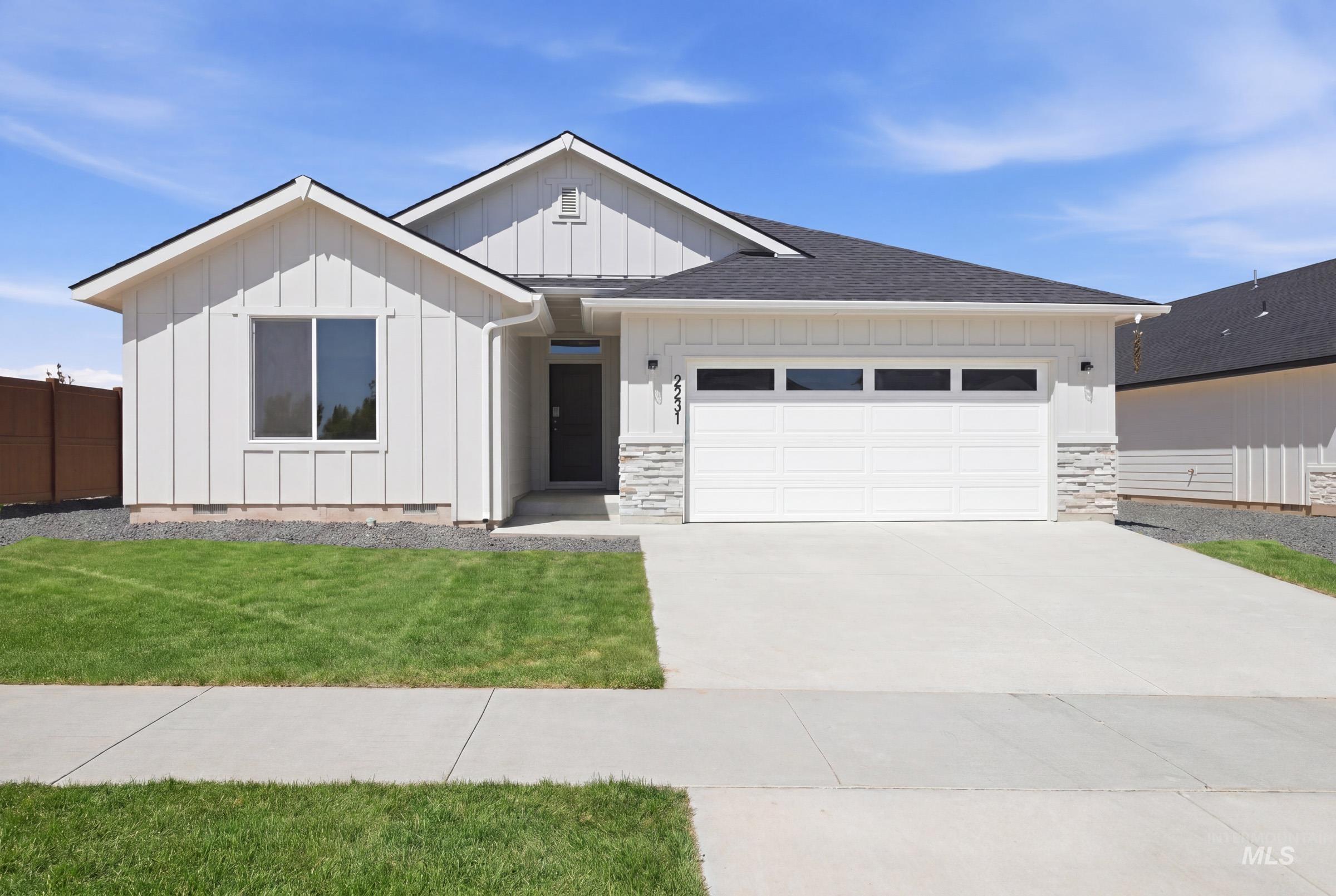 2231 South Border Way Meridian, ID 83642 - Photo 1 of 1 Contemporary single-story residence with a board and batten facade and dark shingle roof