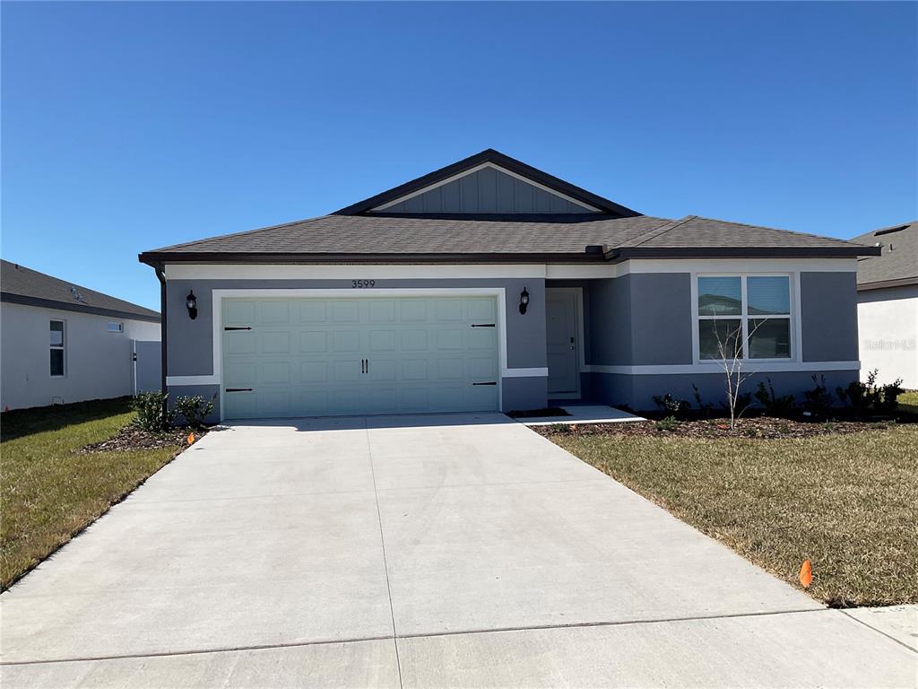 3599 Benham Rise Road Spring Hill, FL 34609 - Photo 1 of 1 a front view of a house with a yard and garage