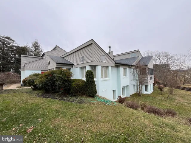 a front view of a house with a garden and yard