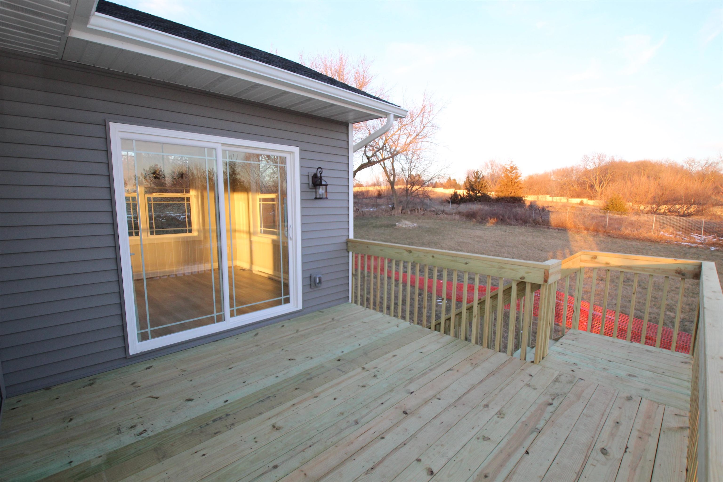 11235 Dublin Drive Roscoe, IL 61073 - Photo 8 of 20 a view of a porch with wooden floor and fence