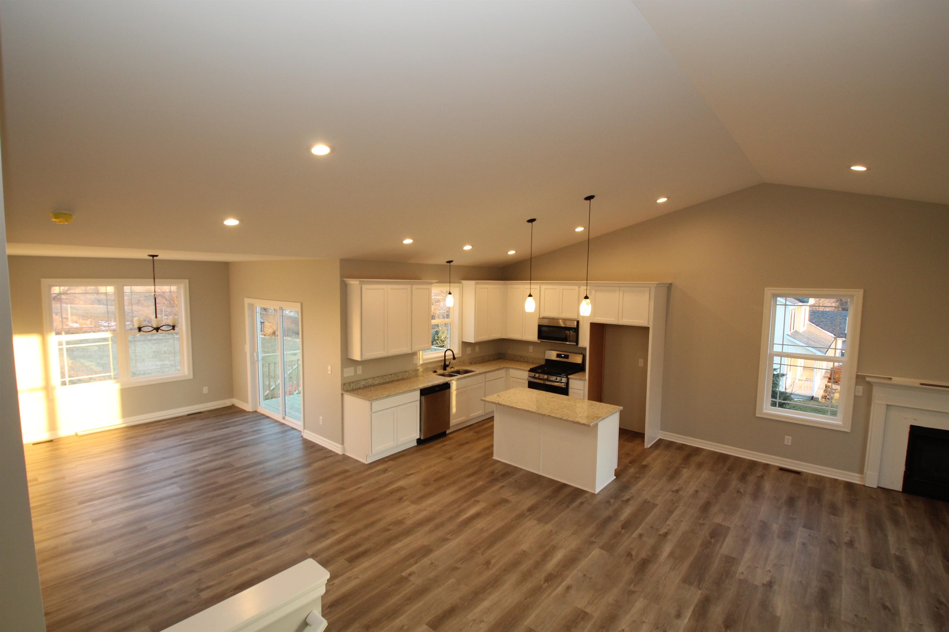 11235 Dublin Drive Roscoe, IL 61073 - Photo 10 of 20 a living room with stainless steel appliances furniture and wooden floor